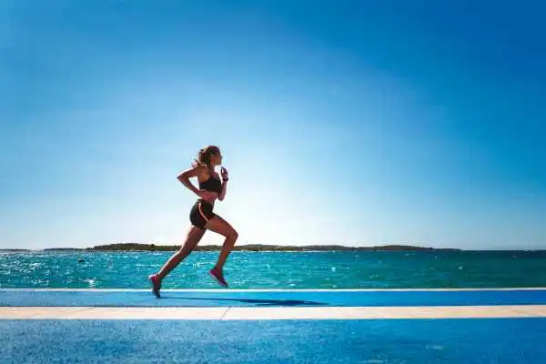 Woman running showing strong leg muscle Uxbridge
